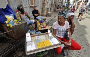 epa12828133 A woman sells candles during a power outage in Havana, Cuba, 17 March 2026. Cuba has been facing a severe energy crisis since mid-2024, and the US oil embargo that began in January has brought the economy near a standstill, fueling growing social unrest.  EPA/Ernesto Mastrascusa